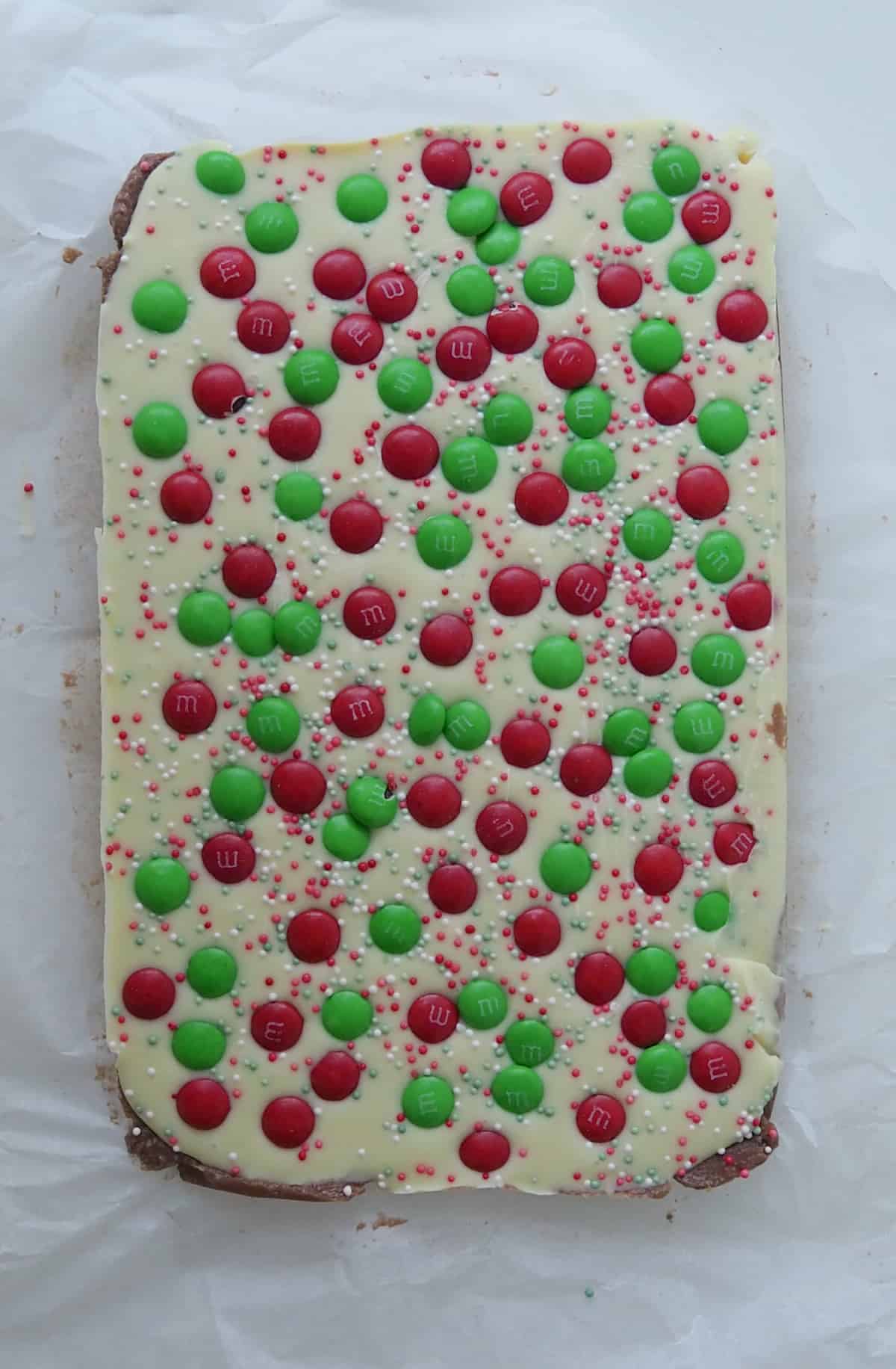 Overhead view of Christmas Slice on a sheet of baking paper before it has been cut.