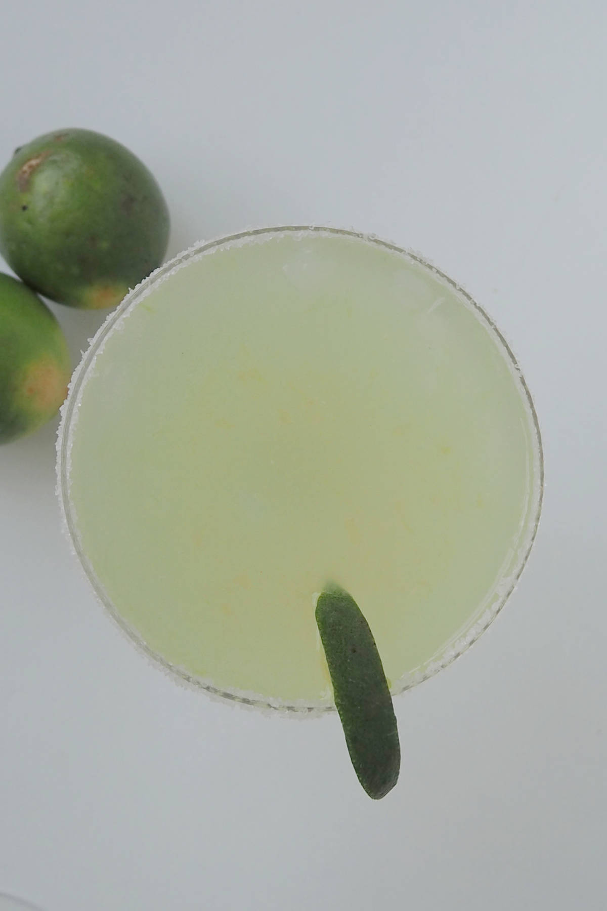 Overhead view of a margarita garnished with lime.
