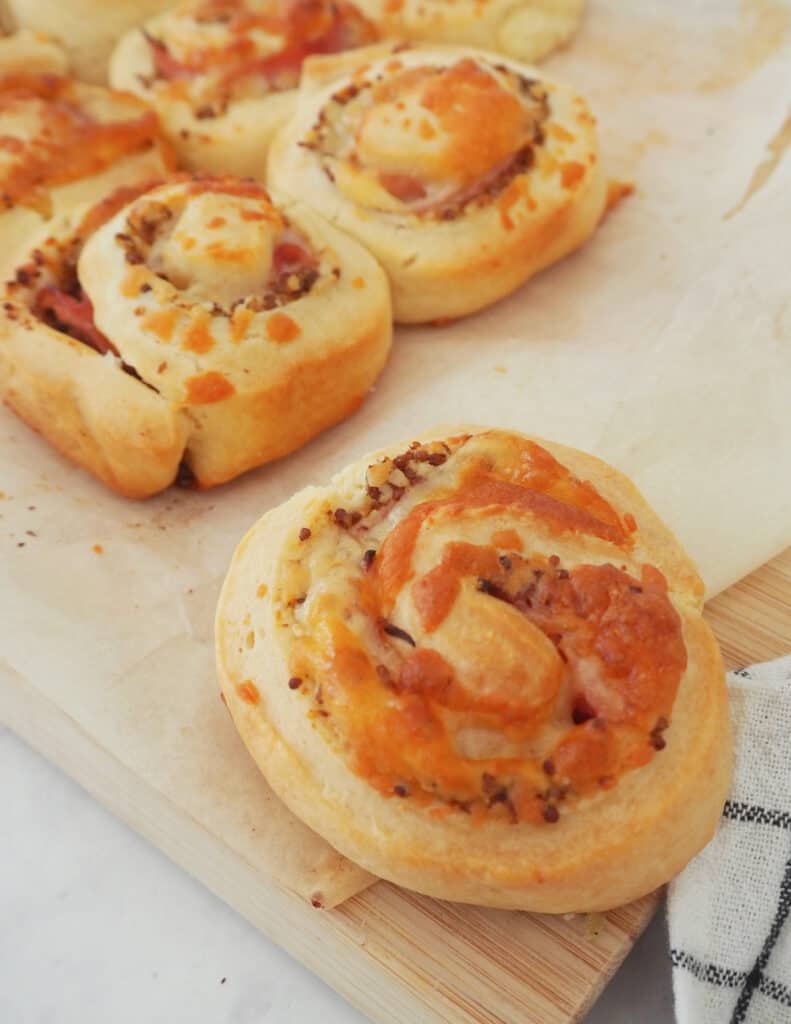 Ham and Cheese Scrolls on a wooden block.
