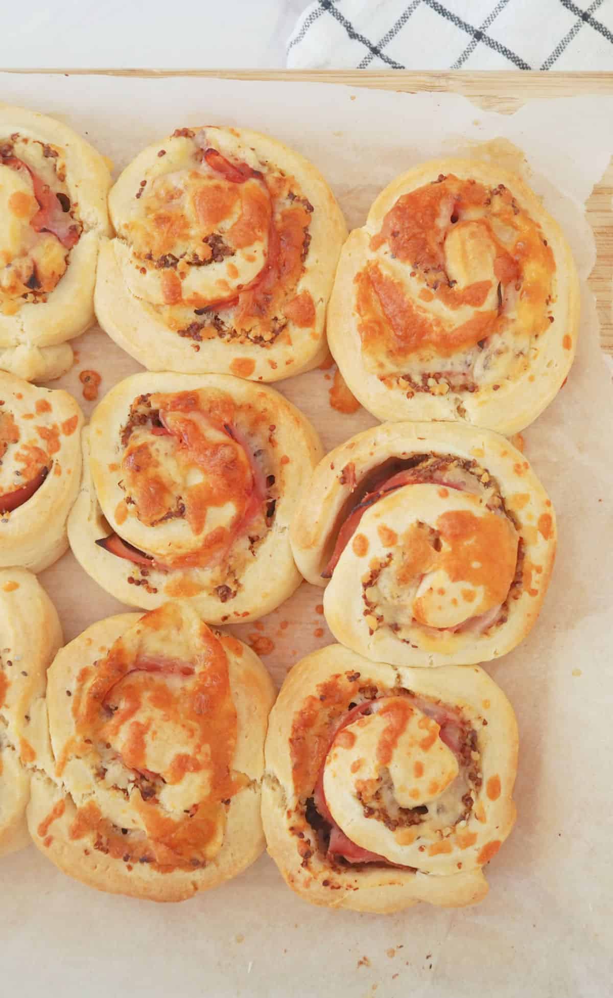 Ham and Cheese Rolls on a sheet of baking paper.