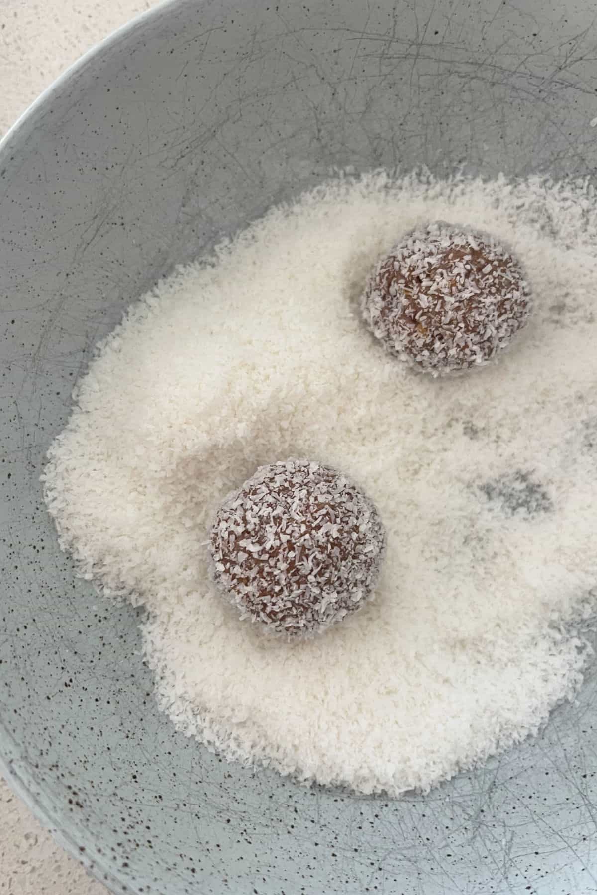 Two Weet-Bix and Milo Balls in a bowl of coconut