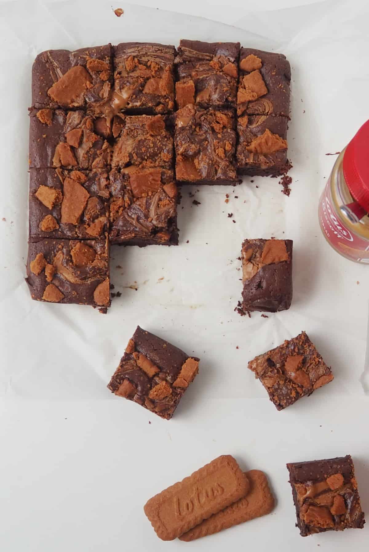 Overhead view of biscoff brownies on a sheet of baking paper.