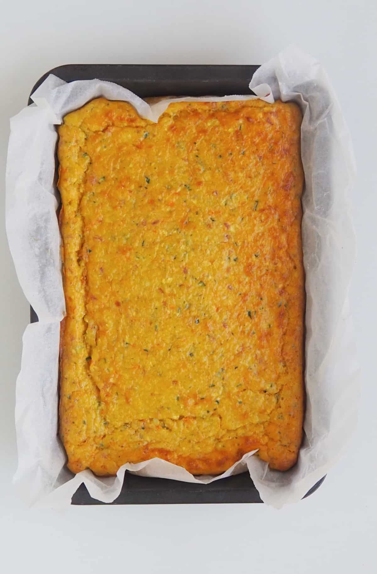 Overhead view of Thermomix zucchini slice in a baking dish straight from the oven.