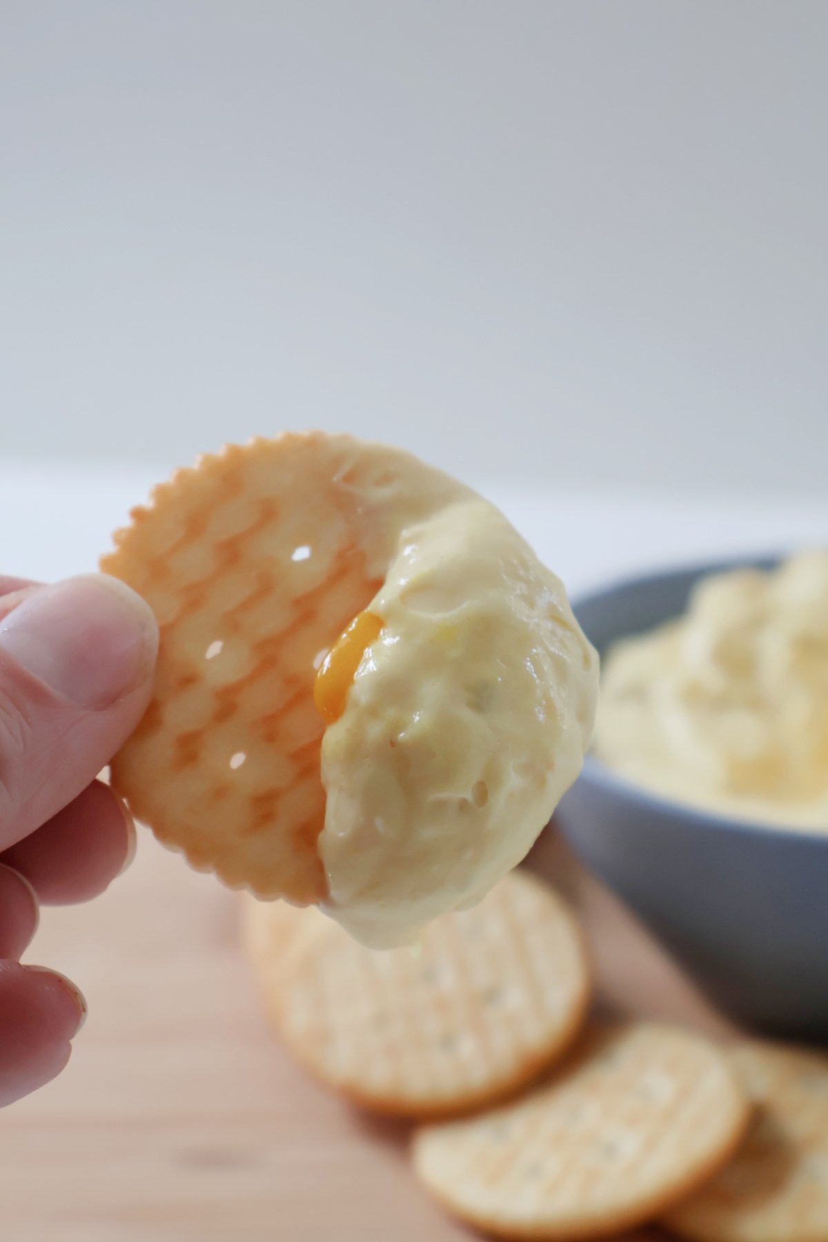 Cracker scooping up corn relish dip.