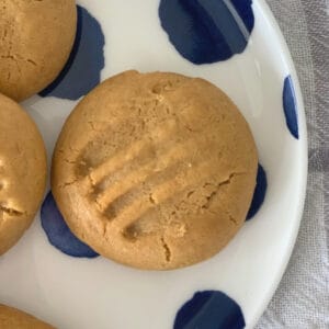 Overhead view of caramel biscuits on a blue spotted plate.