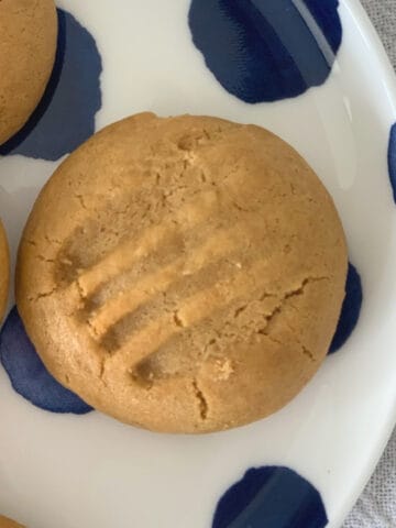 Overhead view of caramel biscuits on a blue spotted plate.