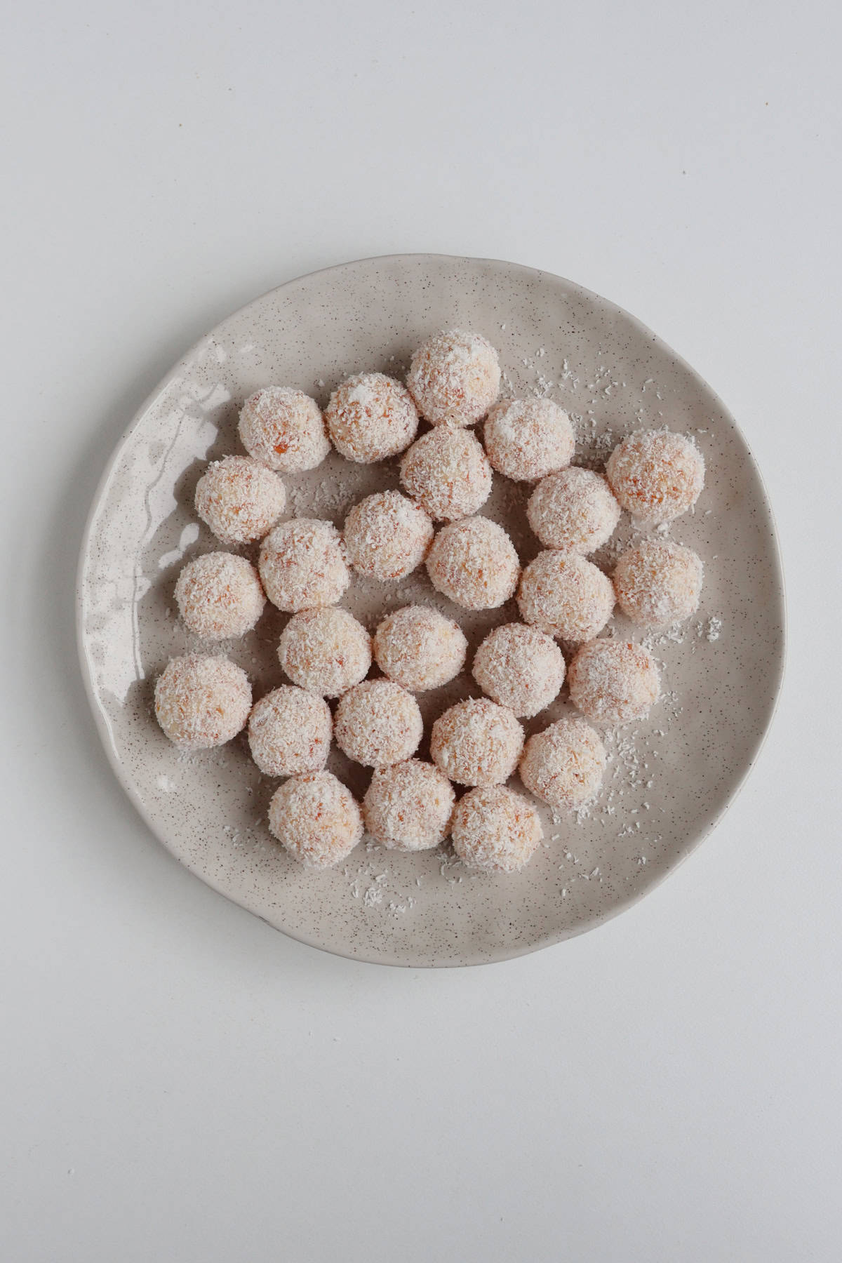 Apricot and Coconut Balls on a plate.