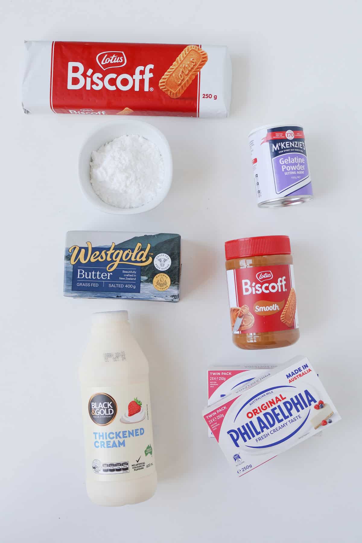 Ingredients to make a Biscoff Cheesecake on a white bench.