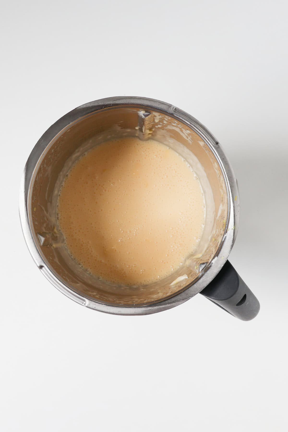 Wet ingredients combined in a thermomix bowl for a lemon and coconut cake.