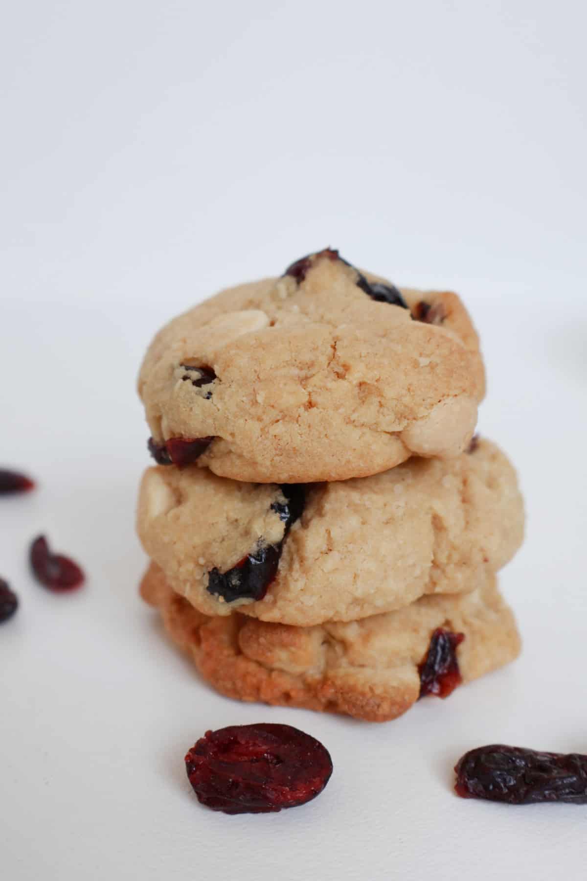 Three White Chocolate and Cranberry Biscuits stacked on top of each other.