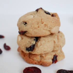 Three White Chocolate and Cranberry Biscuits stacked on top of each other.