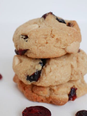 Three White Chocolate and Cranberry Biscuits stacked on top of each other.