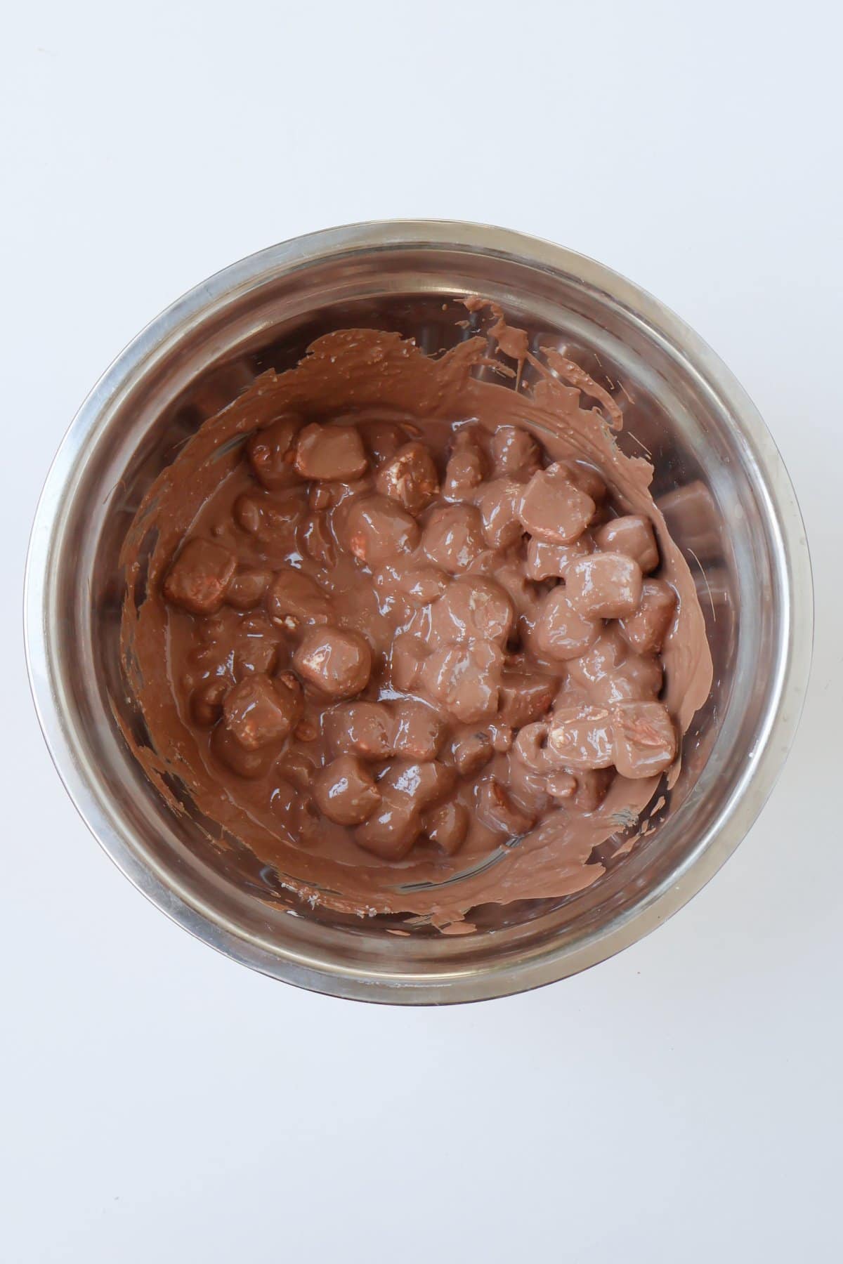 Combined rocky road ingredients in a silver bowl.