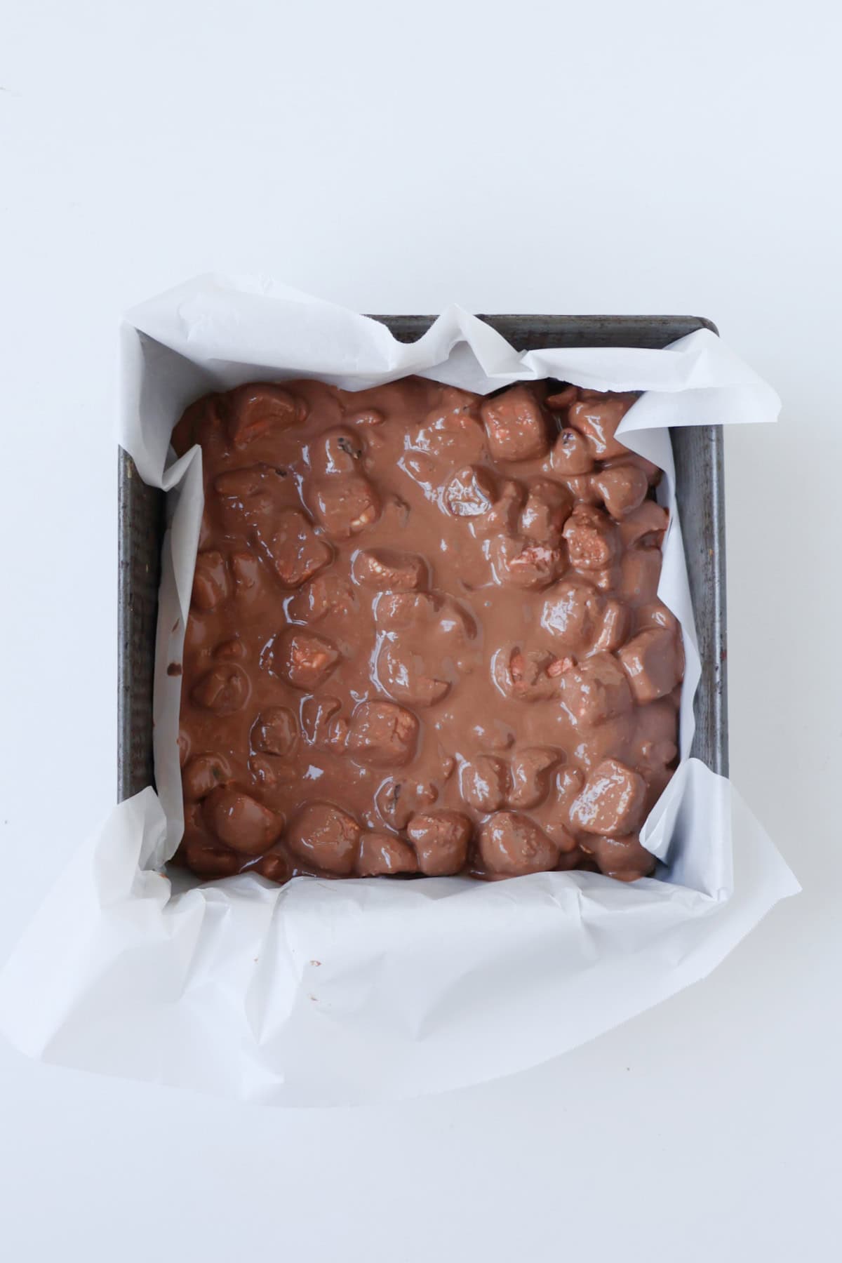 Rocky Road in a square baking dish about to go into the fridge to set.