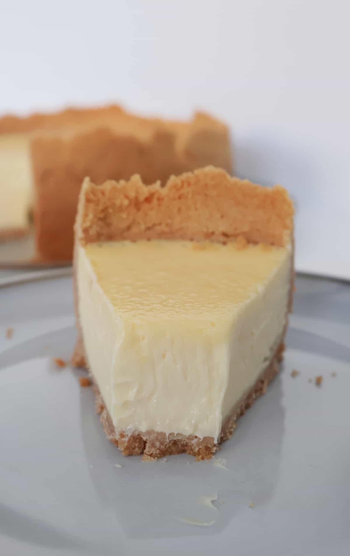 Slice of baked lemon cheesecake on a plate.