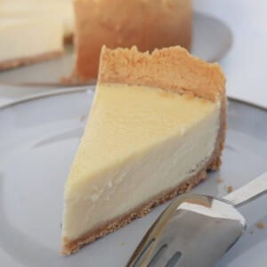 Slice of baked lemon cheesecake on a plate.